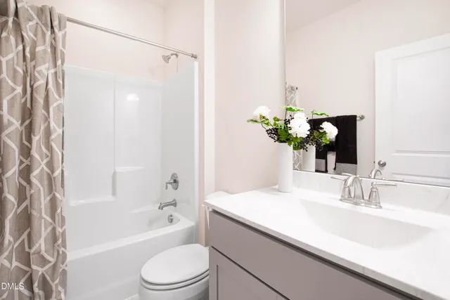 a bathroom with a sink a toilet a bathtub and shower