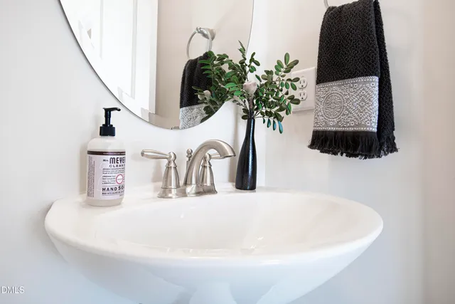 a bathroom with a granite countertop sink a mirror and a shower
