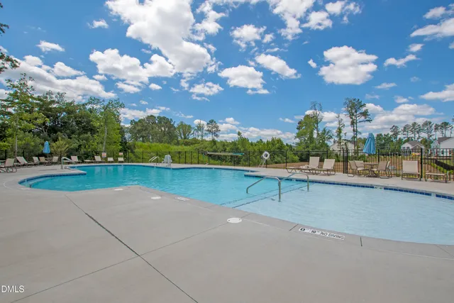 a view of a swimming pool with an outdoor seating and a yard