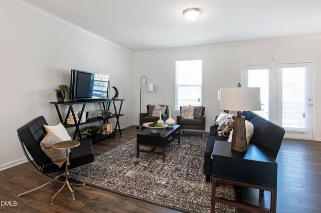 a living room with furniture and wooden floor
