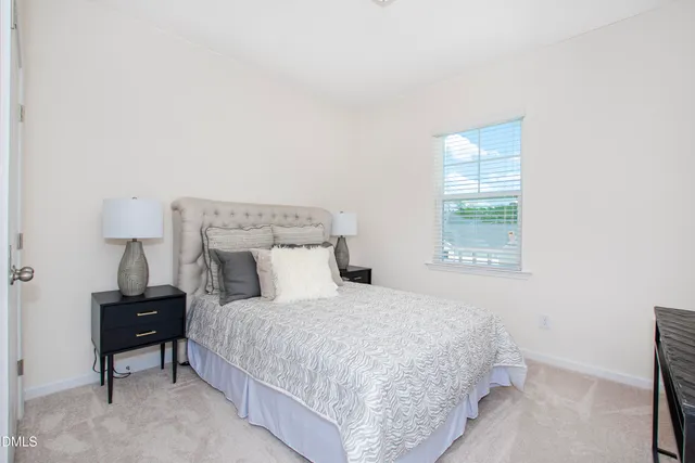 a bedroom with a bed and a lamp