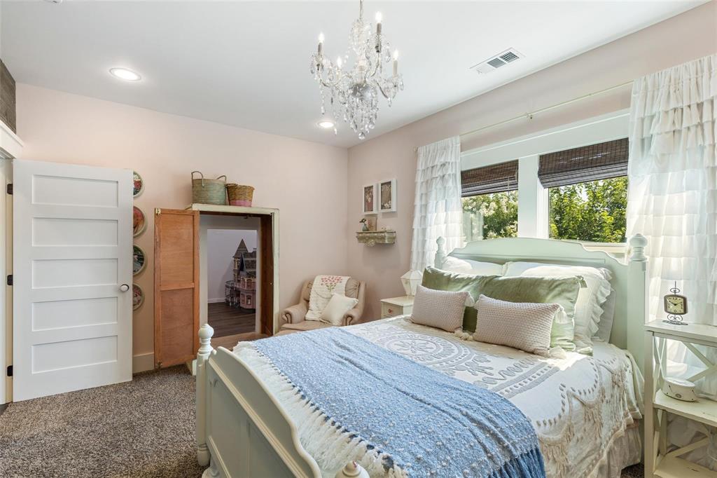 1109 East Oakdale Road Irving, TX 75060 - Photo 27 of 33 a bedroom with a large bed and a chandelier