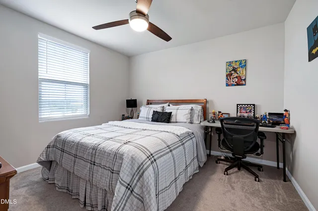 a bedroom that has a bed and a desk in it