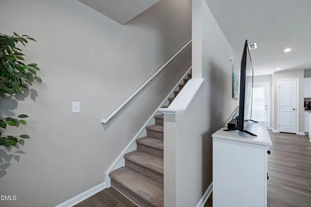 a view of entryway and hall with wooden floor