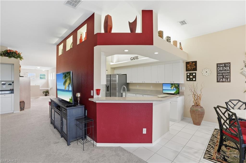10871 Crooked River Road, Unit 202 Estero, FL 34135 - Photo 12 of 46 a living room with furniture and a flat screen tv