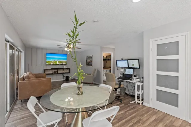 a living room with furniture a chandelier and a flat screen tv