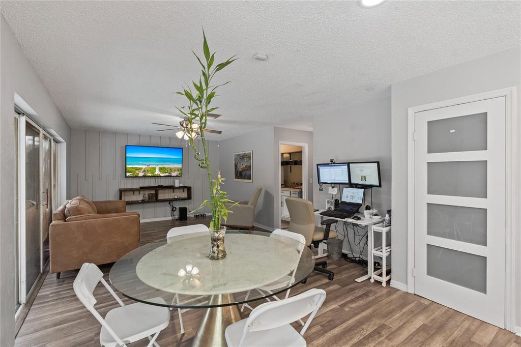 520 Sumter Avenue Davie, FL 33325 - Photo 12 of 44 a living room with furniture a chandelier and a flat screen tv