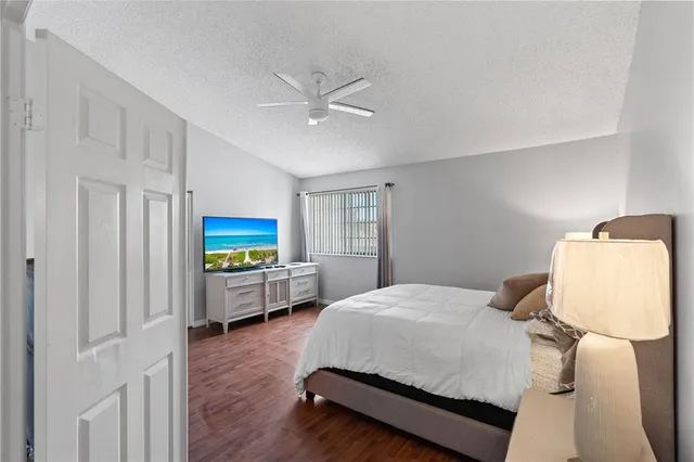 a bedroom with a bed window and dresser