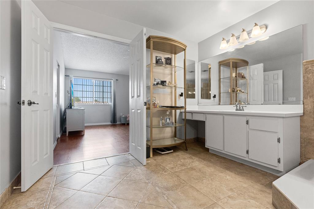 520 Sumter Avenue Davie, FL 33325 - Photo 27 of 44 a spacious bathroom with a double vanity sink a mirror and a shower