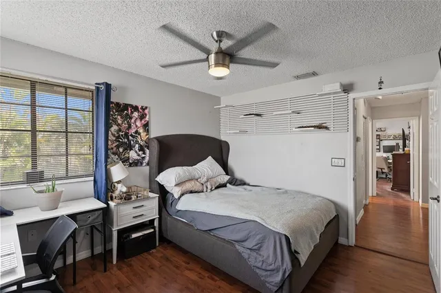 a bedroom with a bed and a table with bookshelf