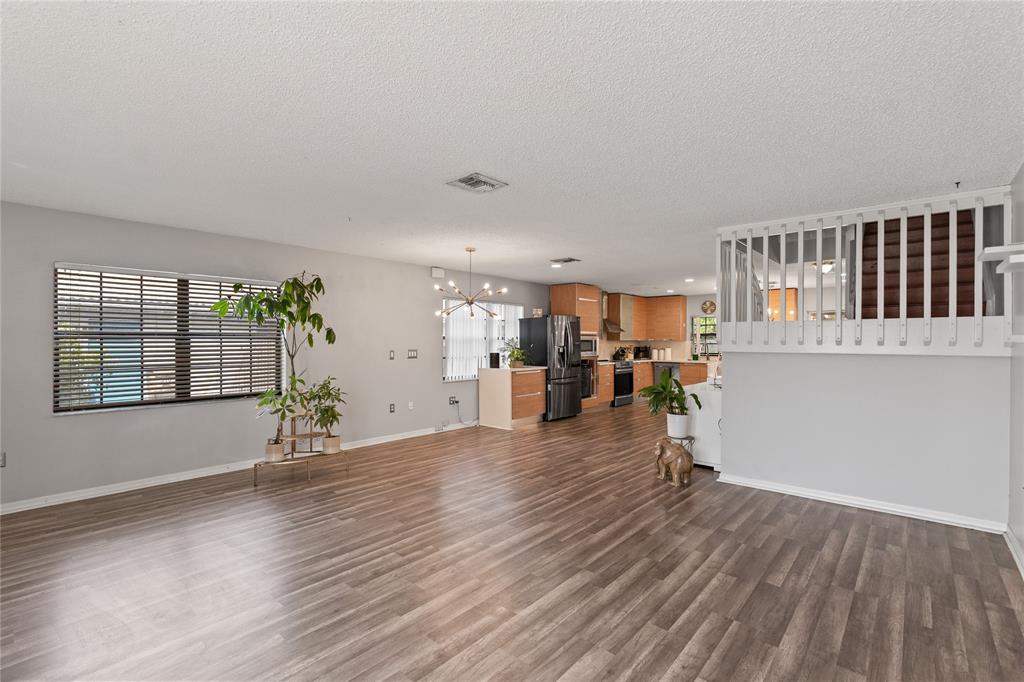 520 Sumter Avenue Davie, FL 33325 - Photo 3 of 44 an empty room with wooden floor and windows