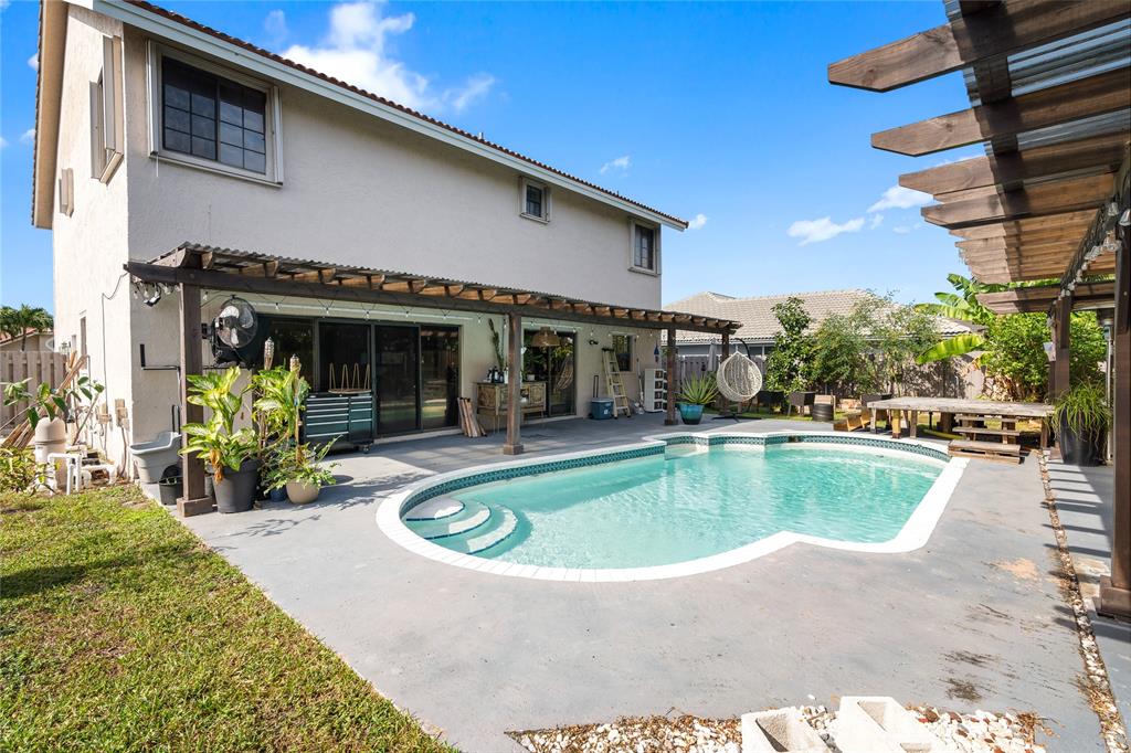 520 Sumter Avenue Davie, FL 33325 - Photo 37 of 44 a view of a house with swimming pool and a porch