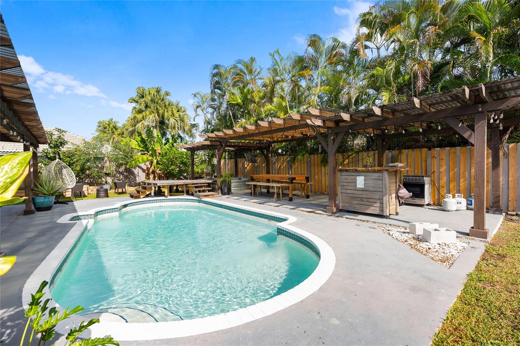 520 Sumter Avenue Davie, FL 33325 - Photo 40 of 44 a view of a swimming pool with a patio