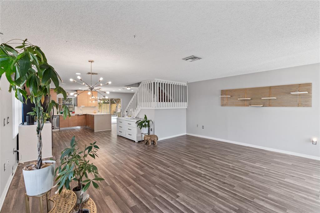 520 Sumter Avenue Davie, FL 33325 - Photo 4 of 44 a view of a work space with potted plants and wooden floor
