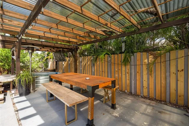 a view of a house with backyard and sitting area