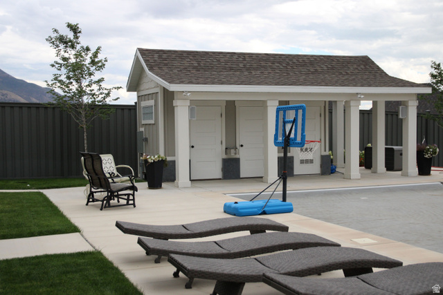 7 Elk Court Alpine, UT 84004 - Photo 6 of 10 Poolside structure featuring a shingled roof, white columns, two exterior doors, and a covered patio area