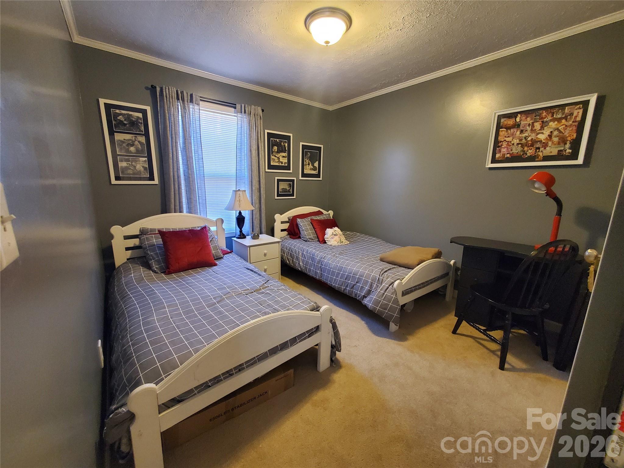 457 Dale Road Spruce Pine, NC 28777 - Photo 17 of 36 a bedroom with bed and a desk