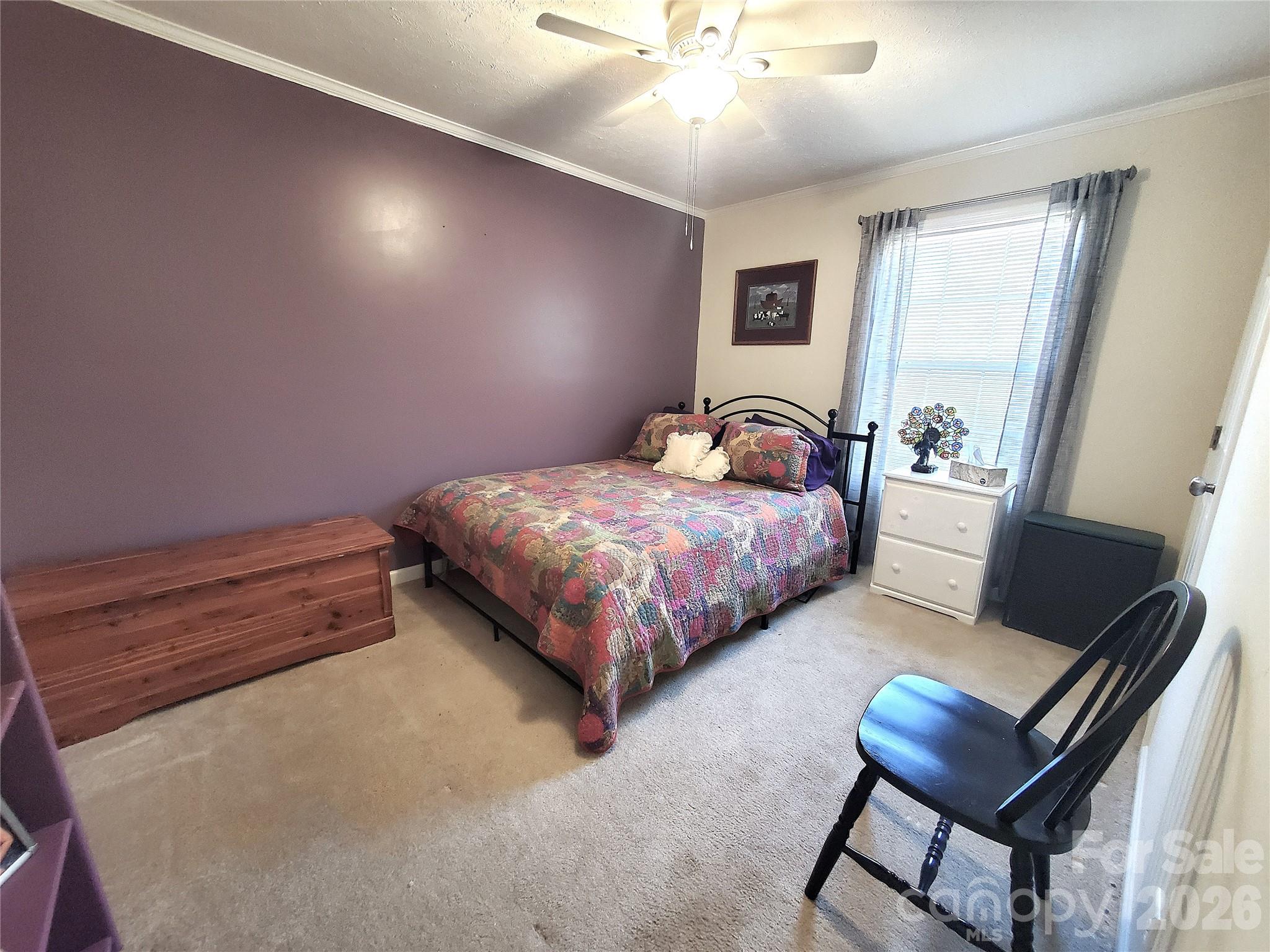 457 Dale Road Spruce Pine, NC 28777 - Photo 21 of 36 a bedroom with a bed and a chandelier