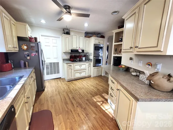 a kitchen with granite countertop lots of counter top space and stainless steel appliances