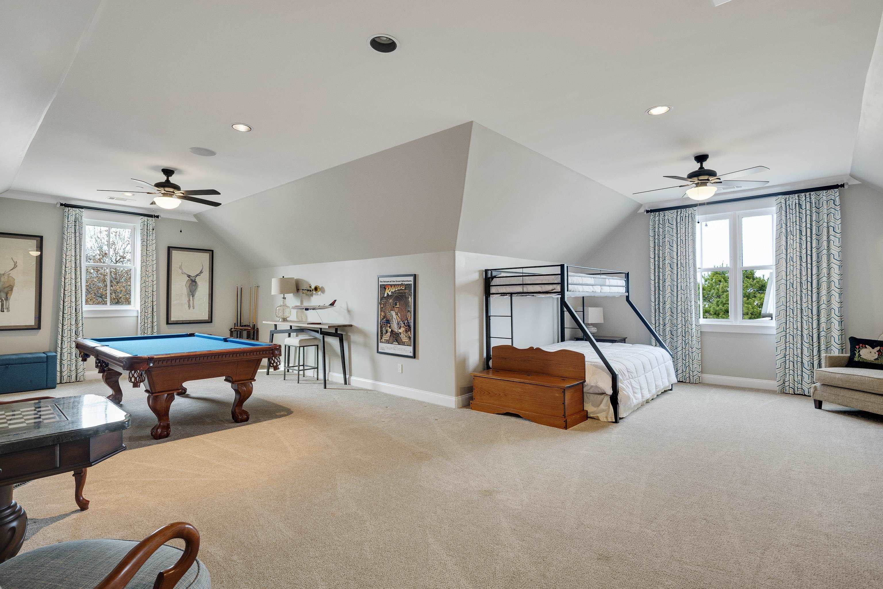 770 Ballard Road Piperton, TN 38017 - Photo 31 of 40 a bedroom with a bed and a chandelier