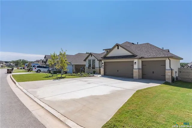 a front view of house with yard and car parked