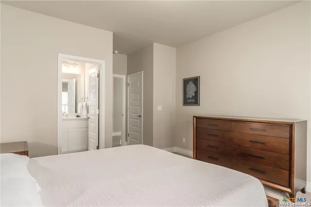 a bedroom with a bed and a dresser