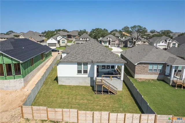 a aerial view of a house with a yard
