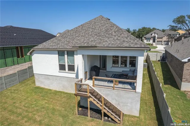 a view of house with backyard and porch