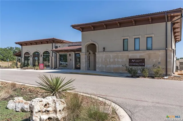 a front view of a house with a parking space