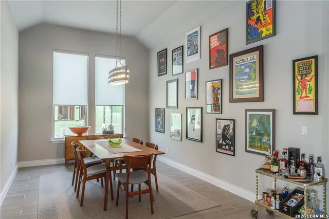 a view of a dining room with furniture and chandelier