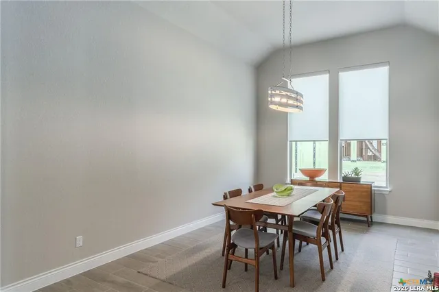 a view of a dining room with furniture and window