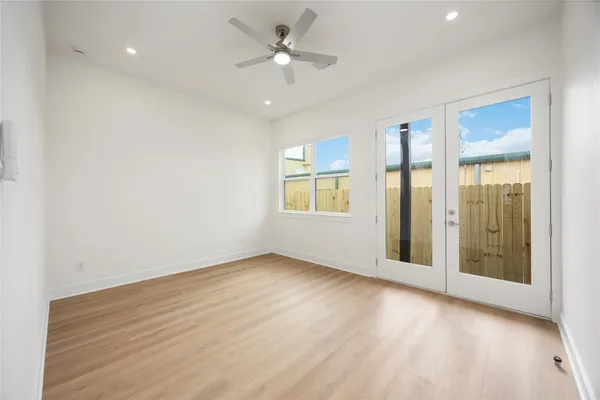 a view of an empty room with glass door and a window