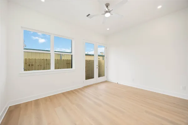 an empty room with a empty space and windows