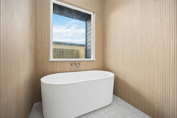 a white bath tub sitting next to a window
