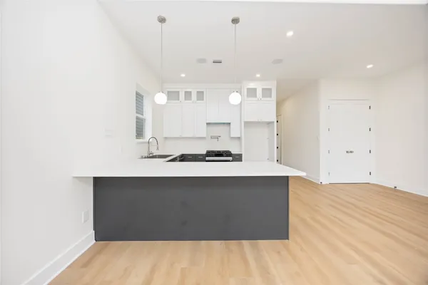 a large kitchen with kitchen island a sink stainless steel appliances and cabinets
