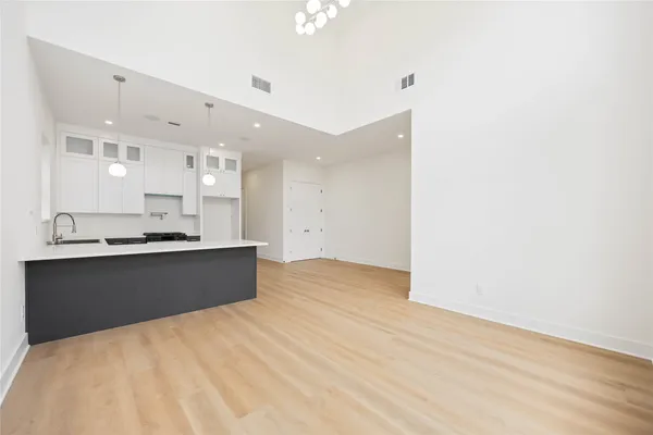 a kitchen with granite countertop a sink and cabinets