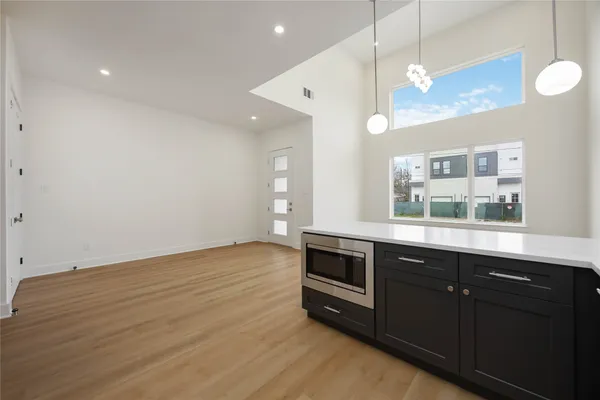 a kitchen with stainless steel appliances granite countertop a stove a sink and a wooden floors