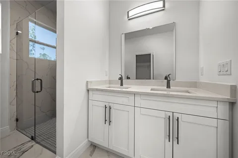 a bathroom with a shower sink and mirror