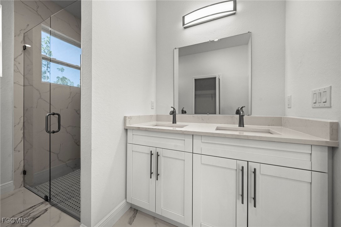 1252 Edna Street East Lehigh Acres, FL 33974 - Photo 14 of 25 a bathroom with a shower sink and mirror