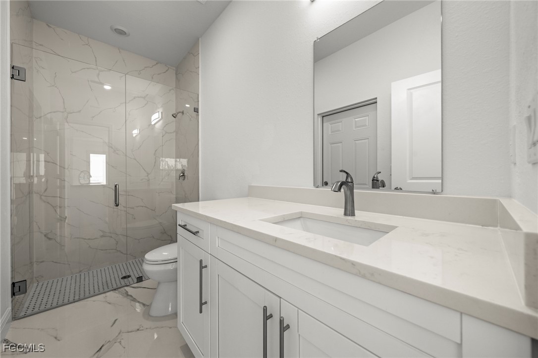 1252 Edna Street East Lehigh Acres, FL 33974 - Photo 15 of 25 a bathroom with a sink toilet and shower