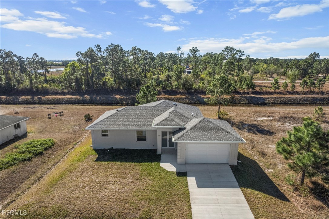 1252 Edna Street East Lehigh Acres, FL 33974 - Photo 2 of 25 a view of a house with a yard