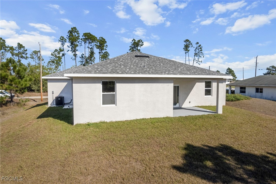 1252 Edna Street East Lehigh Acres, FL 33974 - Photo 23 of 25 a view of a house with a backyard