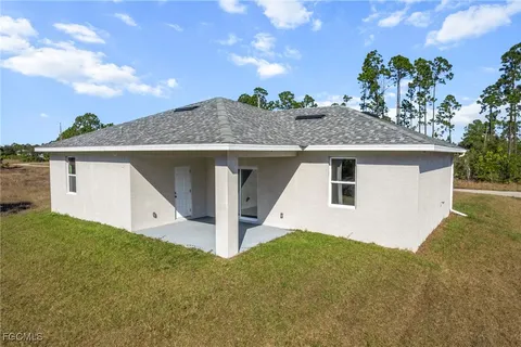 a front view of a house with a yard garage and outdoor seating