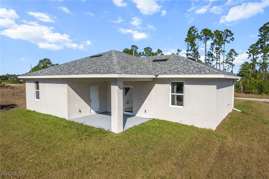 1252 Edna Street East Lehigh Acres, FL 33974 - Photo 25 of 25 a front view of a house with a yard garage and outdoor seating