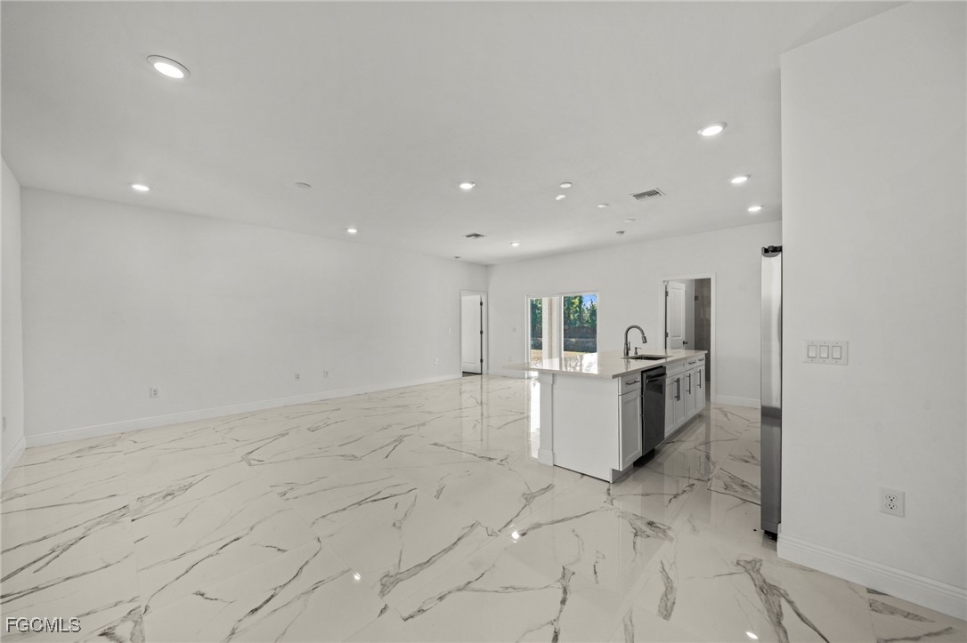 1252 Edna Street East Lehigh Acres, FL 33974 - Photo 5 of 25 a view of kitchen with refrigerator sink and stove