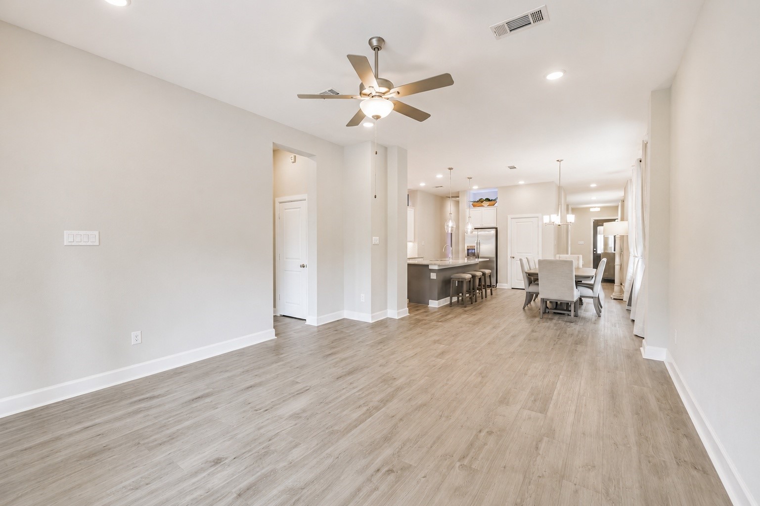 15611 Rising Wren Court Conroe, TX 77302 - Photo 18 of 38 a view of a livingroom with a hardwood floor and a ceiling fan