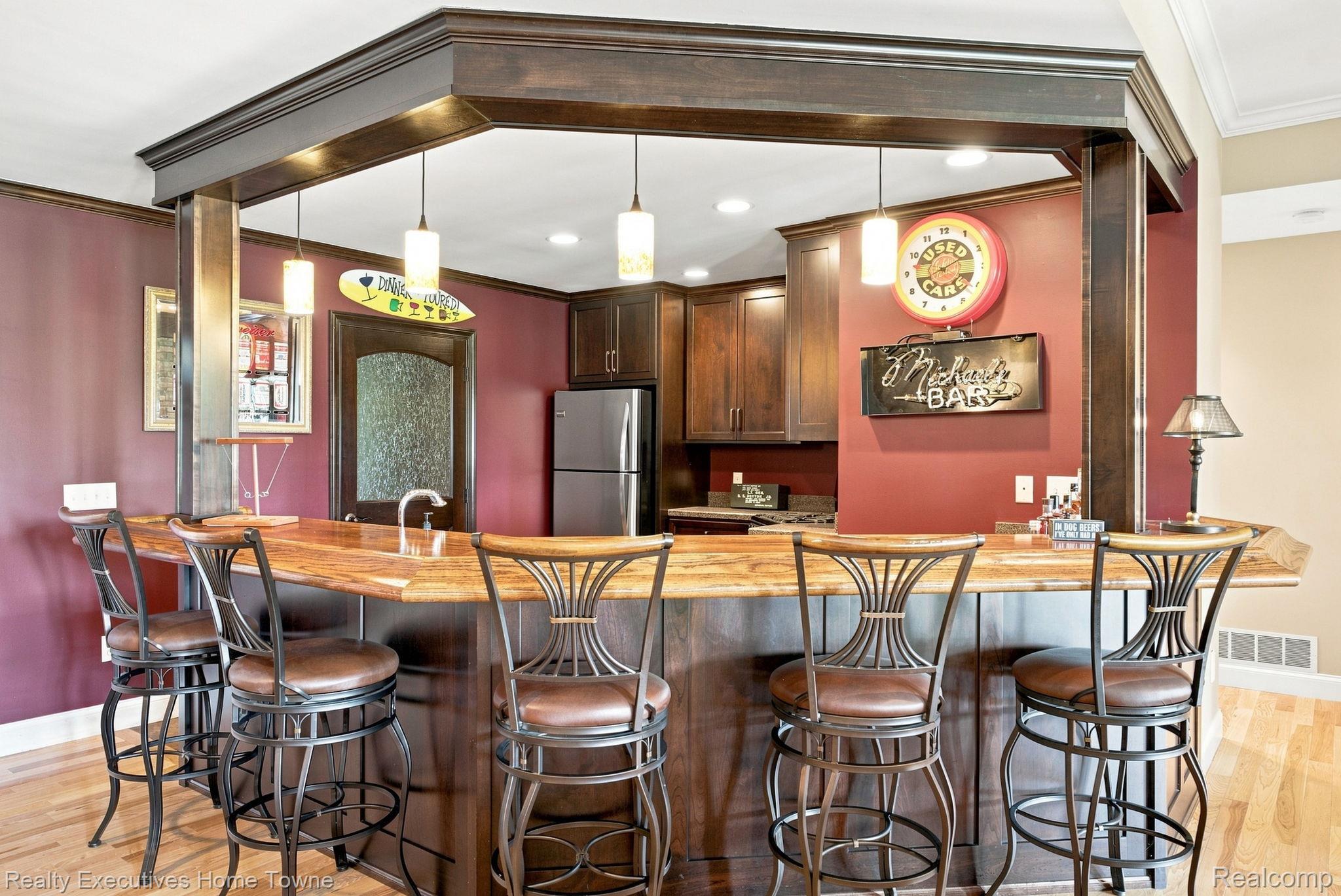 2829 Riverside Drive Port Huron, MI 48060 - Photo 41 of 99 Built-in bar with wood-finish countertop, pendant lighting, and integrated cabinetry