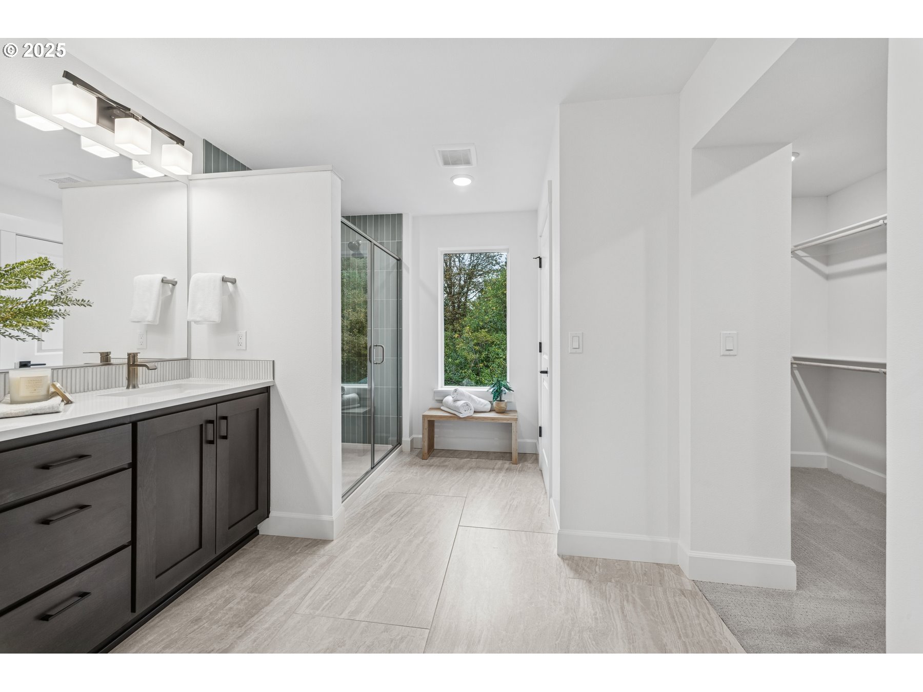 16353 Southwest Cambridge Lane Durham, OR 97224 - Photo 16 of 21 a spacious bathroom with a double vanity sink a large mirror and shower
