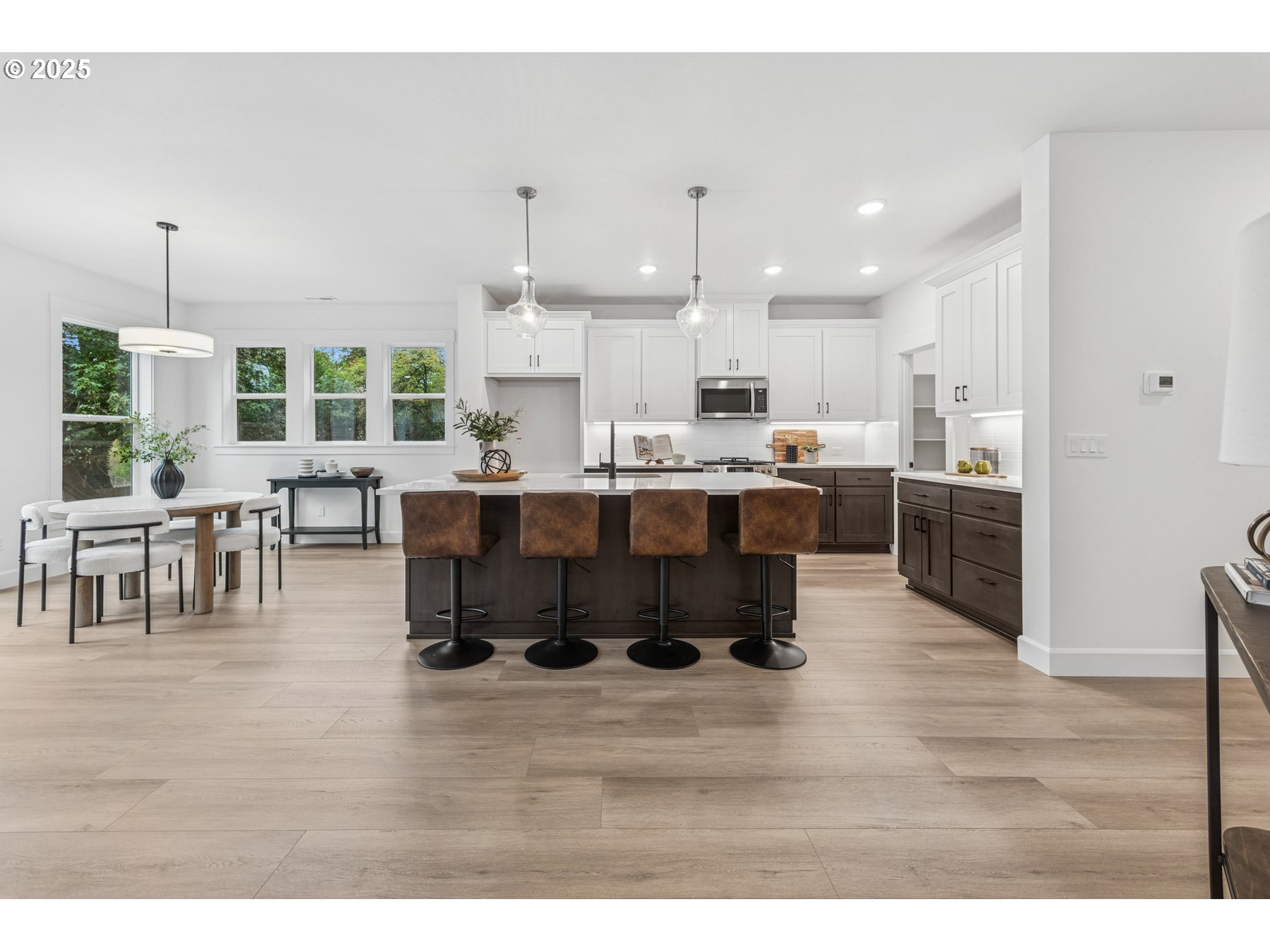 16353 Southwest Cambridge Lane Durham, OR 97224 - Photo 2 of 21 a room with stainless steel appliances kitchen island granite countertop a dining table chairs and granite counter tops