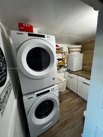 a utility room with sink dryer and washer